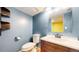 Powder bath with hardwood floors, floating shelves, and a modern vanity at 7682 S Steele St, Centennial, CO 80122
