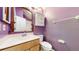 Purple bathroom featuring an ornate mirror, cabinet, and a single vanity at 7682 S Steele St, Centennial, CO 80122