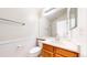 Bright bathroom featuring beadboard paneling, a large mirror, and neutral-toned fixtures at 7682 S Steele St, Centennial, CO 80122
