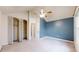 Bedroom featuring a vaulted ceiling, large window, and closet with folding door at 7682 S Steele St, Centennial, CO 80122