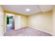 Neutral carpeted bedroom with white trim, base-molding, and door at 7682 S Steele St, Centennial, CO 80122