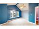 Vaulted bedroom with large bay window, blue accent walls, and neutral carpet at 7682 S Steele St, Centennial, CO 80122