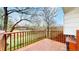 Deck with brown wood railing, providing views of the tree-filled yard at 7682 S Steele St, Centennial, CO 80122