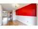 Dining room with wood floors, white wainscoting, and view to front yard at 7682 S Steele St, Centennial, CO 80122