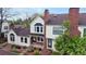 Well-maintained townhome featuring a brick chimney, landscaped yard, and a cozy covered entrance at 7682 S Steele St, Centennial, CO 80122
