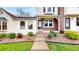 Charming townhome entrance with landscaped front yard and a cozy covered porch at 7682 S Steele St, Centennial, CO 80122