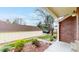View of the brick house and detached garage with ample driveway parking at 7682 S Steele St, Centennial, CO 80122
