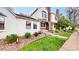 Inviting front yard featuring lush grass, decorative stone, and a well-maintained exterior at 7682 S Steele St, Centennial, CO 80122