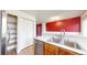 Kitchen sink with stainless steel dishwasher, storage and view to the dining room at 7682 S Steele St, Centennial, CO 80122