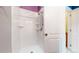 Shower with white tile, built-in shelving, and updated showerhead at 7682 S Steele St, Centennial, CO 80122