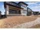 Backyard with a covered patio and newly planted lawn at 8585 Eckley St, Littleton, CO 80125