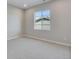 Neutral bedroom featuring carpeted floors, baseboards, and a window offering natural light at 8585 Eckley St, Littleton, CO 80125