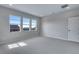 Bright bedroom with large windows, light gray carpet, and neutral walls at 8585 Eckley St, Littleton, CO 80125