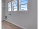 A sunlit bedroom with light-colored walls and three bright windows at 8585 Eckley St, Littleton, CO 80125