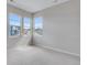 Carpeted bedroom with three bright windows allowing plenty of natural light at 8585 Eckley St, Littleton, CO 80125