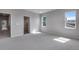 Bright bedroom with neutral carpet, gray walls, and ensuite bathroom and closet at 8585 Eckley St, Littleton, CO 80125