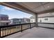 Covered porch with rail overlooking the neighborhood at 8585 Eckley St, Littleton, CO 80125