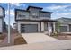 Modern two-story home with a gray garage door at 8585 Eckley St, Littleton, CO 80125