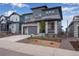 Two-story home featuring stone and gray siding at 8585 Eckley St, Littleton, CO 80125