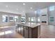 Spacious kitchen and open-concept living area with an island, modern appliances and hardwood floors at 8585 Eckley St, Littleton, CO 80125