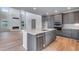 Well-equipped kitchen with stainless steel appliances, gray cabinetry, and an island at 8585 Eckley St, Littleton, CO 80125
