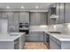 Modern kitchen with quartz countertops, gray cabinets, tiled backsplash and stainless appliances at 8585 Eckley St, Littleton, CO 80125
