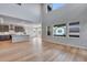 Bright, open living area flows into a kitchen with hardwood floors and gray cabinets at 8585 Eckley St, Littleton, CO 80125