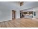 Spacious living area that connects to the kitchen, featuring hardwood floors and light gray walls at 8585 Eckley St, Littleton, CO 80125