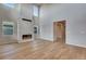 Spacious living area with fireplace, hardwood floors, high ceilings, and lots of natural light at 8585 Eckley St, Littleton, CO 80125