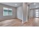 Neutral living room showcasing wood-look floors, a large window, and an open floorplan concept at 8585 Eckley St, Littleton, CO 80125