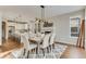 Dining area with hardwood floors and open view into the kitchen at 989 Deer Clover Way, Castle Pines, CO 80108