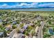Scenic aerial view of a neighborhood with a lake and mountain range providing a picturesque backdrop at 9125 W 95Th Ave, Westminster, CO 80021