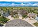 This community aerial view highlights the circular driveway and beautiful mountain views in the distance at 9125 W 95Th Ave, Westminster, CO 80021