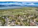 Aerial shot displaying homes in a green neighborhood with tranquil lake and mountain views at 9125 W 95Th Ave, Westminster, CO 80021