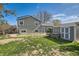 A large backyard has a mix of lawn, storage and a patio with stairs that lead to a deck at 9125 W 95Th Ave, Westminster, CO 80021
