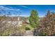 This landscaped backyard boasts privacy trees, a white fence and a mix of lawn and garden at 9125 W 95Th Ave, Westminster, CO 80021