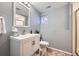 Bright bathroom featuring a white vanity, framed mirror and a tiled shower and neutral wall color at 9125 W 95Th Ave, Westminster, CO 80021