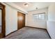 A cozy, carpeted bedroom with a window and a closet for storage with neutral wall color at 9125 W 95Th Ave, Westminster, CO 80021
