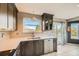 Modern kitchen with quartz countertops and views of the exterior deck at 9125 W 95Th Ave, Westminster, CO 80021