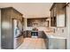 Spacious kitchen with stainless steel appliances, quartz countertops, and tile flooring at 9125 W 95Th Ave, Westminster, CO 80021