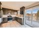Well-equipped kitchen with stainless steel appliances and access to a large deck at 9125 W 95Th Ave, Westminster, CO 80021