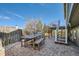 Brick patio has an outdoor table and built-in benches as well as access to a deck via stairs at 9125 W 95Th Ave, Westminster, CO 80021