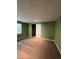 Finished basement with neutral carpet, window and white door at 1148 S Duquesne Cir, Aurora, CO 80018