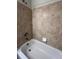 Cozy bathroom featuring tiled walls and a bathtub at 1148 S Duquesne Cir, Aurora, CO 80018