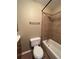 Cozy bathroom featuring a toilet and shower/tub combination with tile surround at 1148 S Duquesne Cir, Aurora, CO 80018