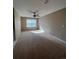 Spacious bedroom with carpet, ceiling fan, and window, perfect for comfort and relaxation at 1148 S Duquesne Cir, Aurora, CO 80018