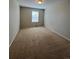 Inviting bedroom featuring neutral walls, plush carpeting, and a window for natural light at 1148 S Duquesne Cir, Aurora, CO 80018