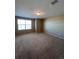 Bright bedroom with carpet flooring and a large window providing ample natural light at 1148 S Duquesne Cir, Aurora, CO 80018