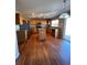Well-equipped kitchen featuring wood cabinets, stainless steel appliances, and beautiful wood floors at 1148 S Duquesne Cir, Aurora, CO 80018