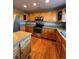 Modern kitchen boasting stainless steel appliances, wood cabinets, granite countertops, and hardwood floors at 1148 S Duquesne Cir, Aurora, CO 80018